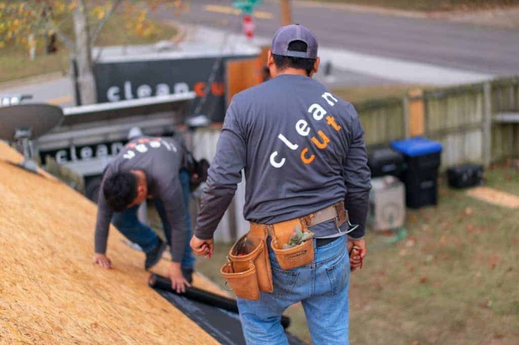 Clean Cut roofing crew on a job in branded shirts
